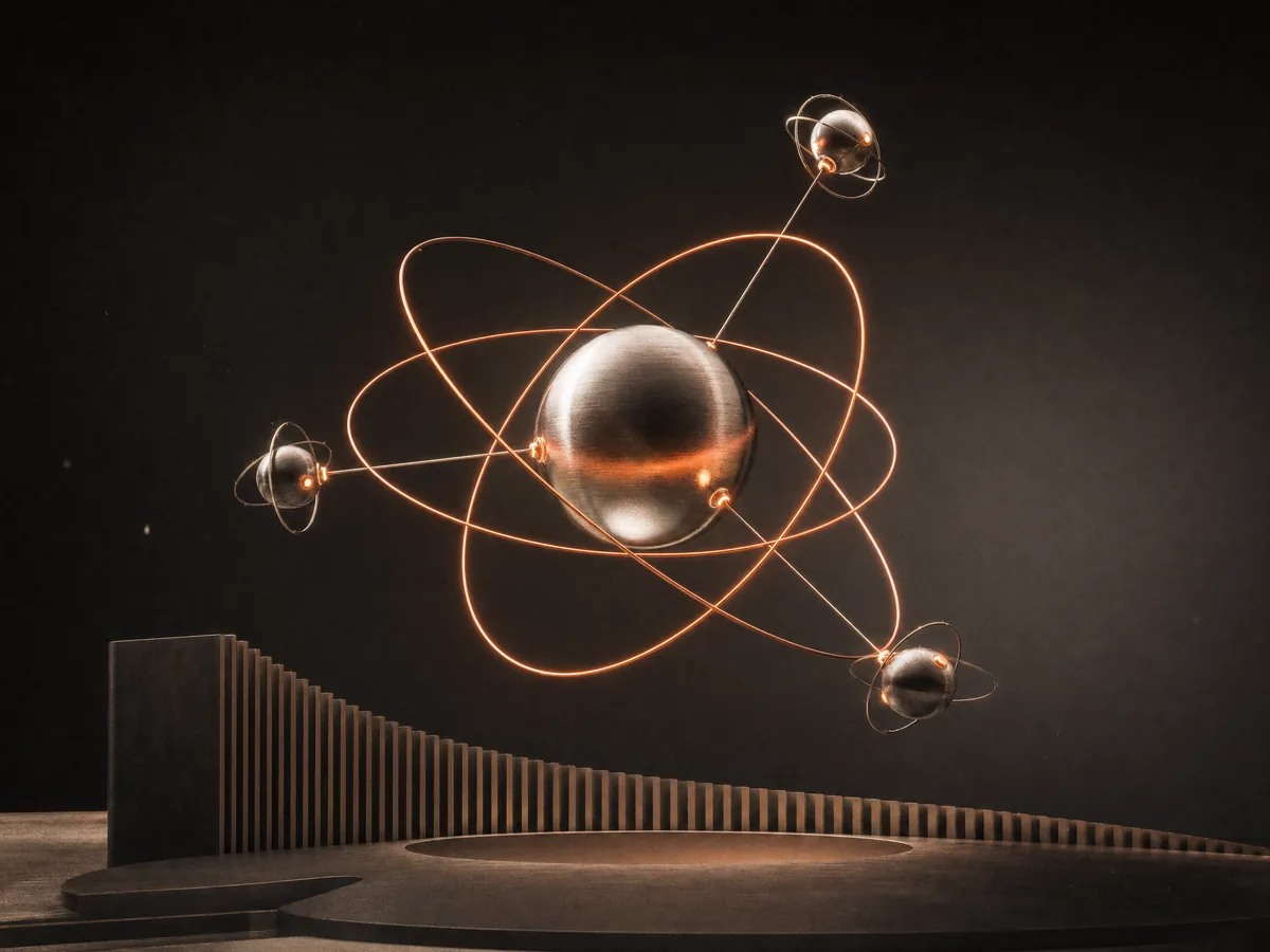 A titanium sphere with coral signal rings, an illustration of broadcast infrastructure